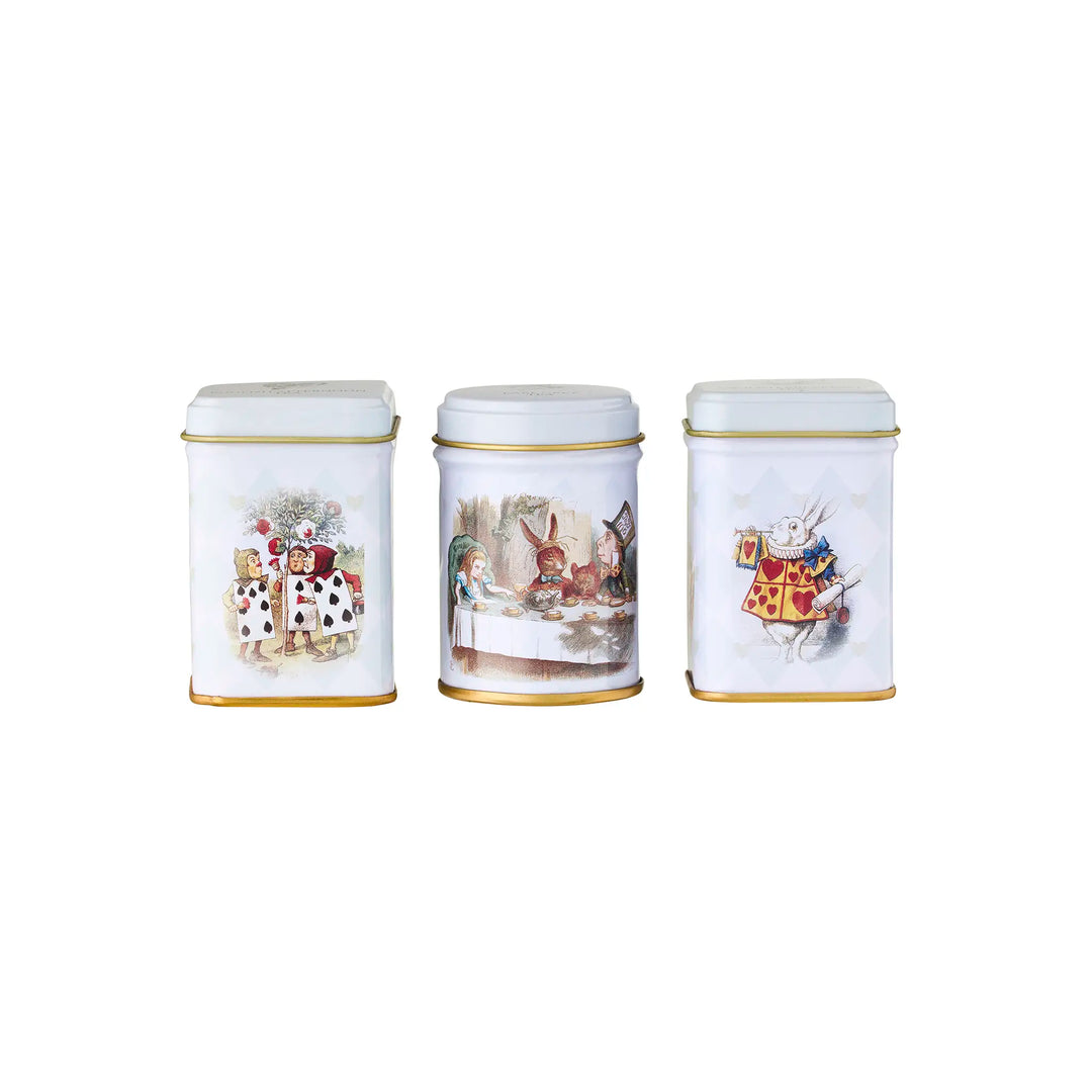 Three white tea canisters with Alice in Wonderland illustrations on a white background