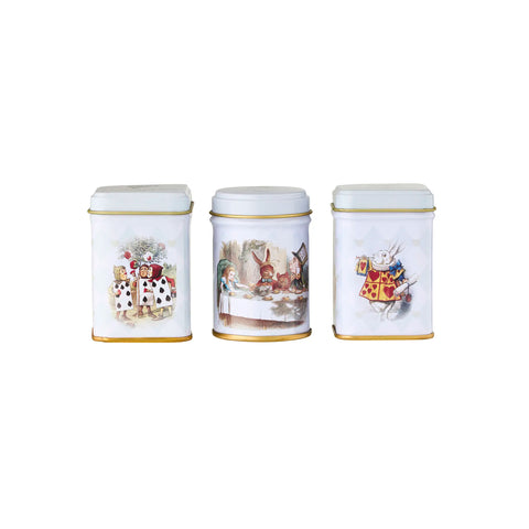 Three white tea canisters with Alice in Wonderland illustrations on a white background