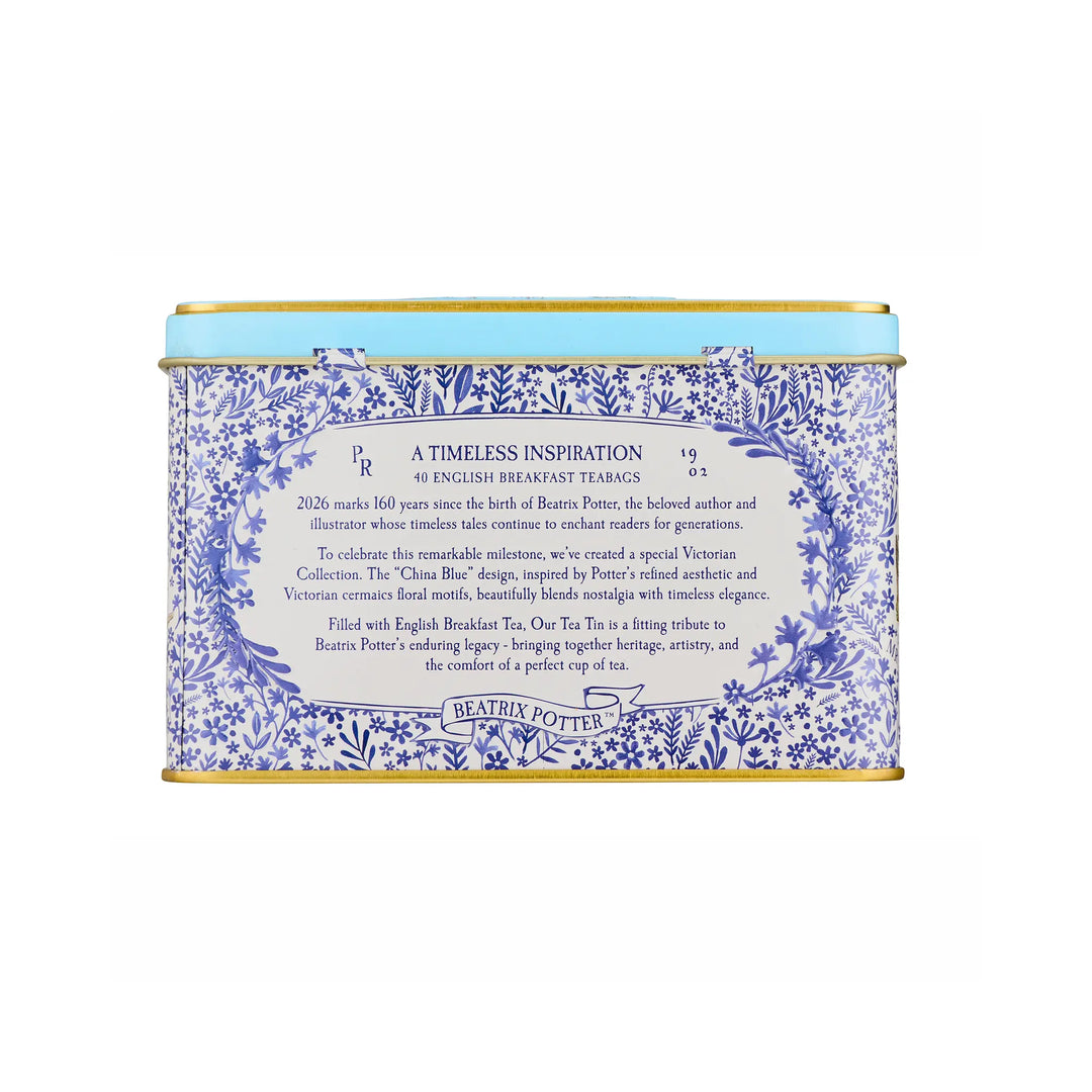 A square metal tin of Beatrix Potters 160th Anniversary English Breakfast Tea, featuring a blue and white floral pattern with a light blue top band and gold-toned rims.