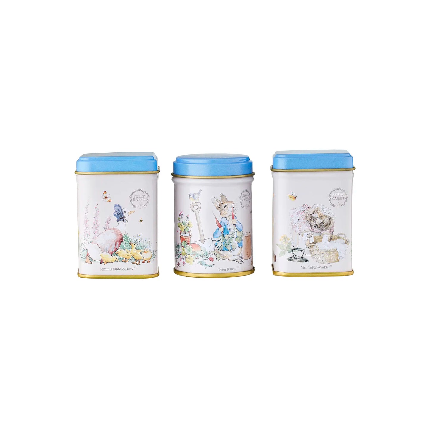 Three tea tins with Beatrix Potter themed illustrated lids on a white background
