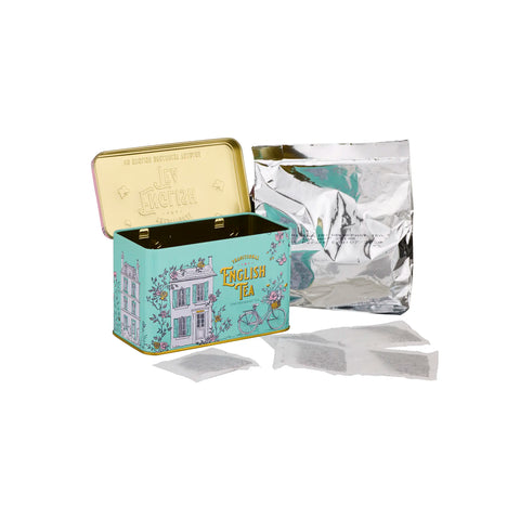 Tea tin with decorative design and tea bags on a white background