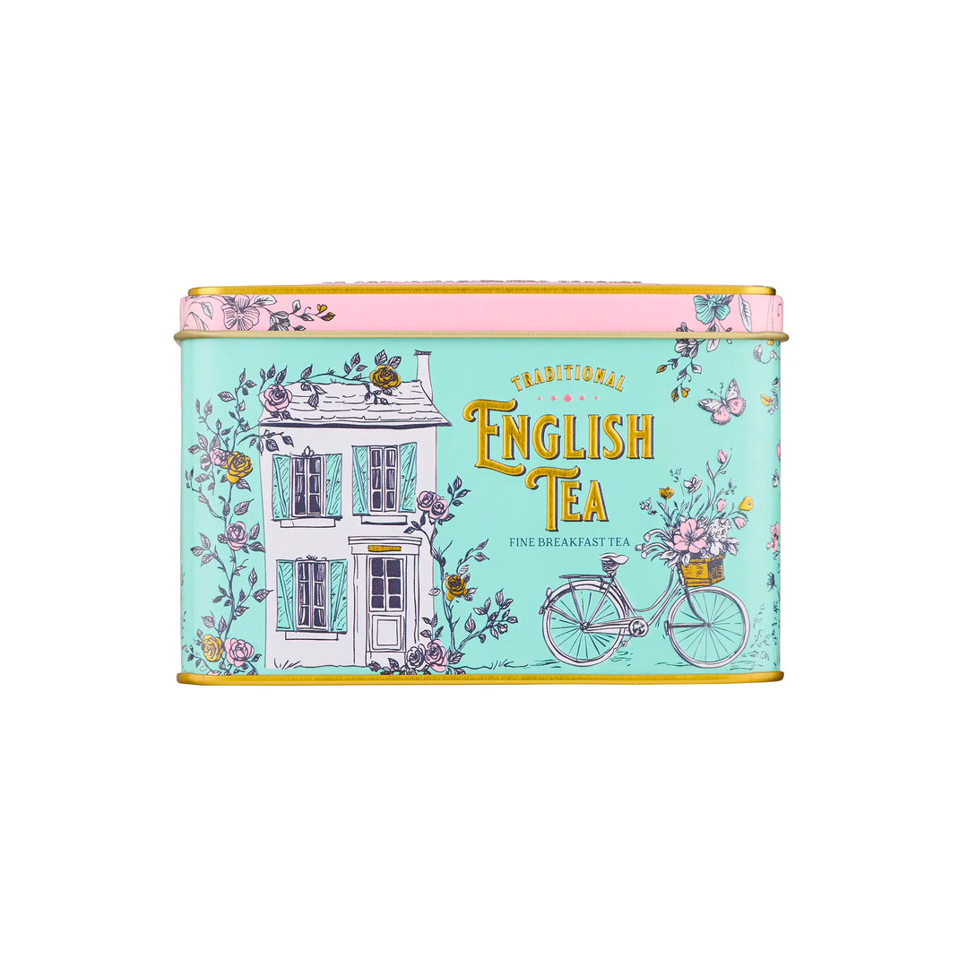 Tea tin with decorative design featuring a house and bicycle on a light blue background