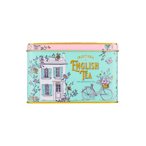 Tea tin with decorative design featuring a house and bicycle on a light blue background