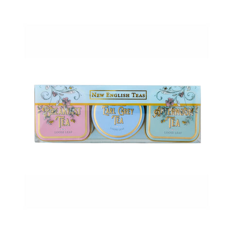 A boxed set of three New English Tea tins in pastel colors: pink for Breakfast Tea, light blue for Earl Grey Tea, and pale blue for Afternoon Tea, with gold lettering and decorative floral details.