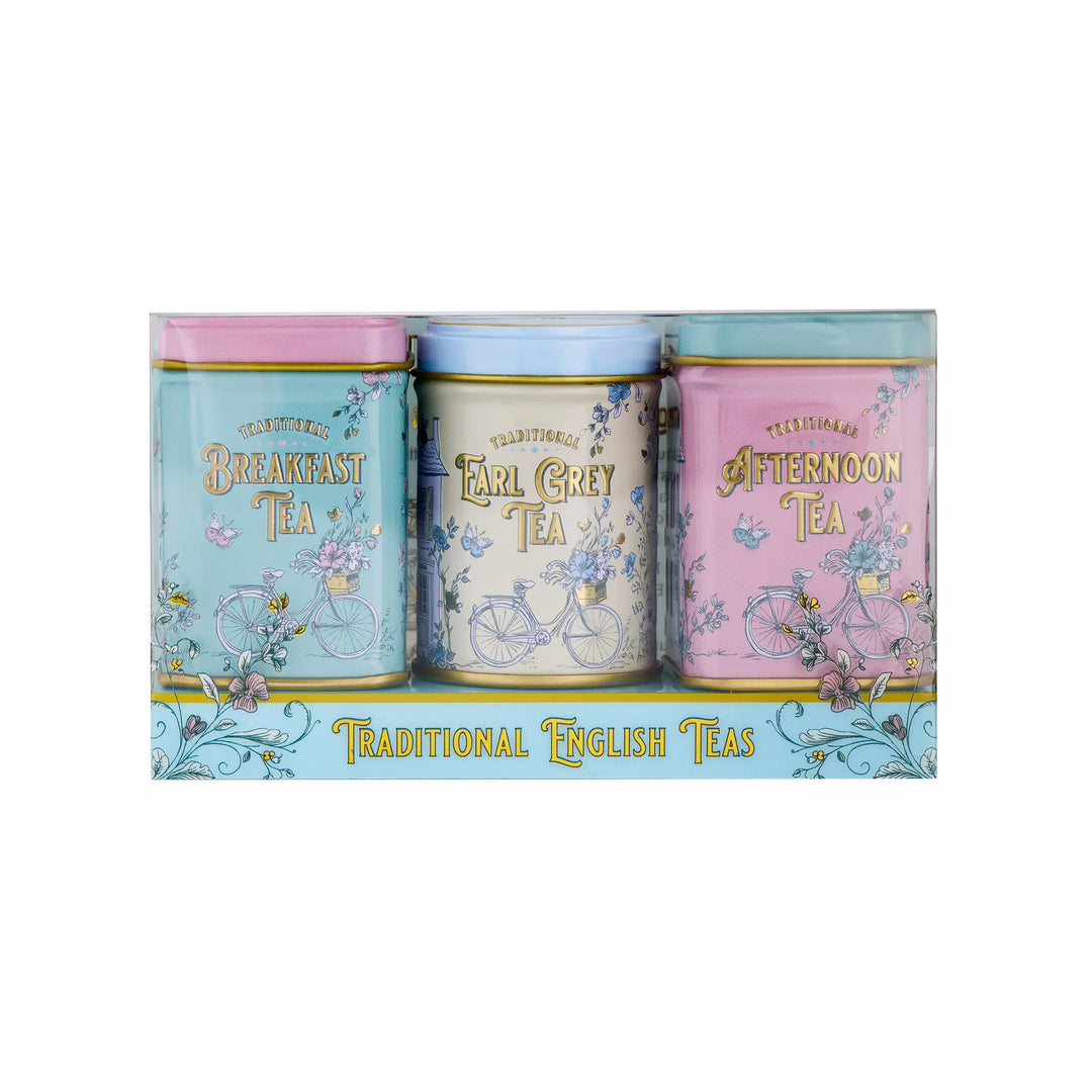 A set of three decorative tea tins in a clear plastic box, labeled Breakfast Tea, Earl Grey Tea, and Afternoon Tea, with pastel blue, pink, and light blue designs featuring bicycles and floral accents.