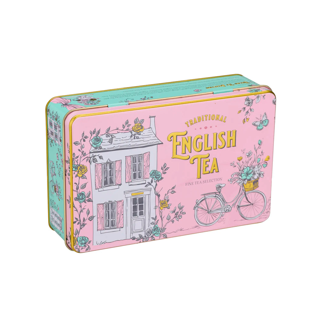 A rectangular metal tin of English Tea Selections, decorated with a pink house, bicycle, and floral motifs on a light pink background.