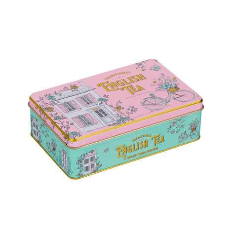 A decorative rectangular metal tin of traditional English tea, featuring a pink lid with a bicycle and house illustration, and a mint green side panel with gold lettering.