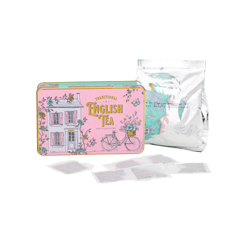 A pink tin of English Tea with floral illustrations of a house and bicycle, shown with a silver foil pouch and several tea bags on a white background.