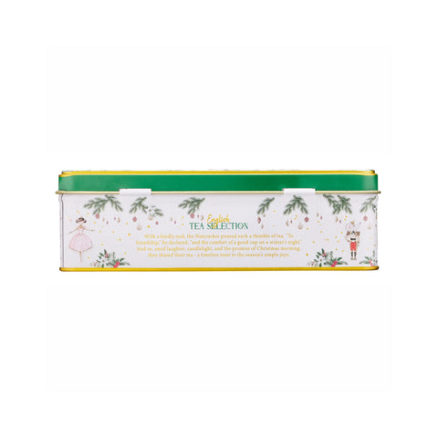 A rectangular metal tea tin with a white body, green lid, and gold trim, decorated with Christmas illustrations including a nutcracker, a ballerina, pine branches, and gold confetti. The front text reads 'English TEA SELECTION'.