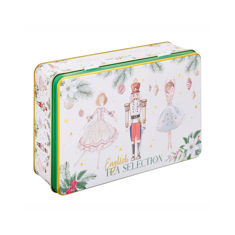 A rectangular metal tea tin with a white background decorated with Christmas illustrations, including a nutcracker, ballerinas, pine branches, ornaments, and the text 'English TEA SELECTION'.