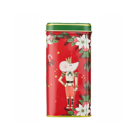 A rectangular red tin with a green lid, decorated with a festive nutcracker illustration, white flowers, and green holly leaves on a plain white background.