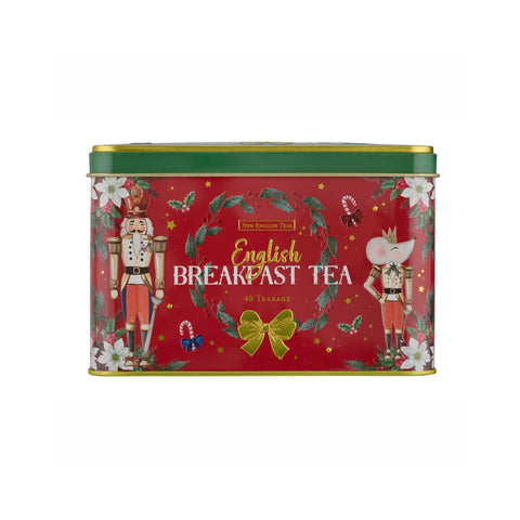 A rectangular red tin of New English Teas English Breakfast Tea, decorated with festive Christmas illustrations including nutcrackers, a green wreath, white flowers, and a gold bow.