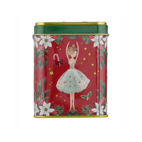 A rectangular metal tin with a festive Christmas design, featuring a ballerina in a light blue tutu on a red background with white poinsettias, green holly leaves, and gold stars. The tin has a dark green lid with gold trim and is shown against a plain white background.