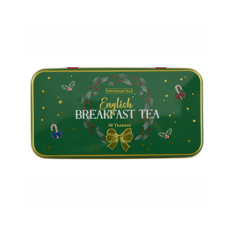 A rectangular green metal tin of New English Tea English Breakfast Tea, decorated with a wreath, gold bow, and festive illustrations, on a plain white background.