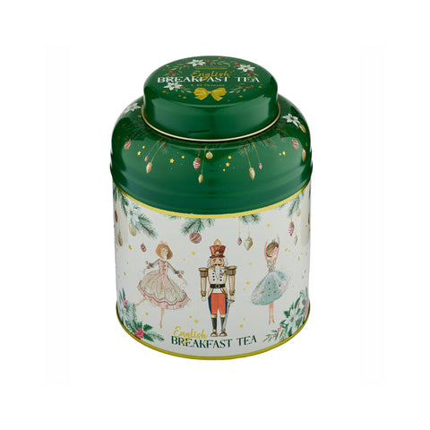 A round metal tea tin with a green lid and a cream-colored body decorated with illustrations of a nutcracker, a woman in a pink dress, and a woman in a blue dress, along with the text 'English Breakfast Tea'.