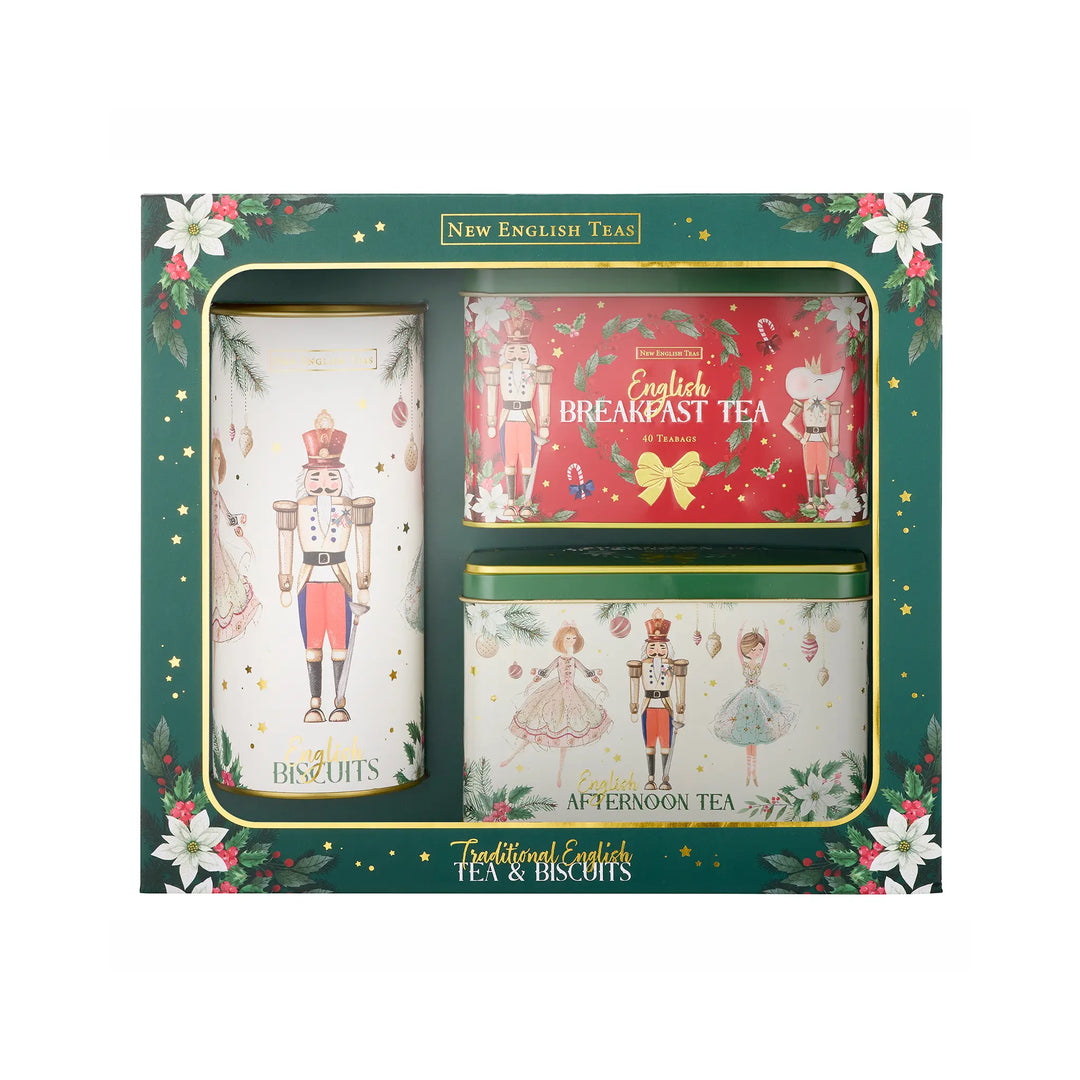 New English Tea Traditional English Tea & Biscuits gift set in a dark green box with floral borders. The set includes a large tin of Biscuits, a tin of Breakfast Tea, and a tin of Afternoon Tea, all decorated with festive nutcracker and ballerina illustrations.