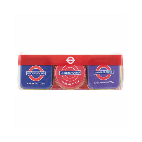 A three-pack of London Underground themed tea tins in a clear plastic clamshell package. The tins feature the iconic roundel logo and text 'UNDERGROUND' with 'BREAKFAST TEA', 'EARL GREY TEA', and 'AFTERNOON TEA' printed below.