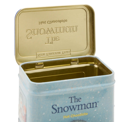 Open tin of 'The Snowman' hot chocolate with gold lid on a white background