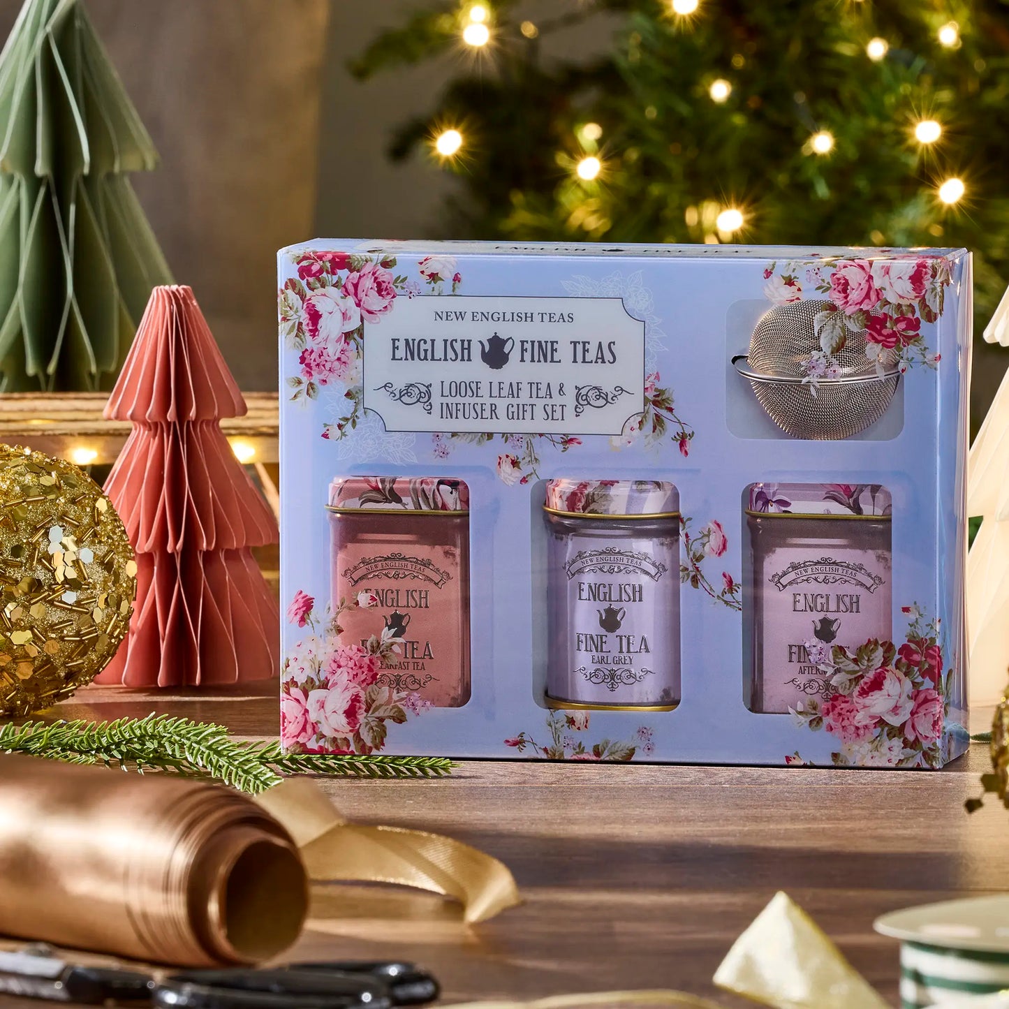 Tea gift set packaging with floral designs on a decorative background