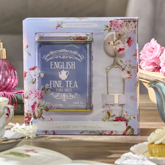 Floral packaging of English Fine Tea Earl Grey Gift Set with a teacup and roses in the background
