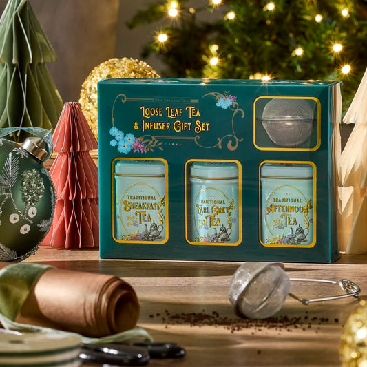 Vintage Victorian Loose leaf tea and infuser gift set with Christmas decorations in the background by New English Teas